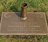 Bronze marker with integrated vase.